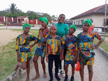 Girls in colourful dress with a mentor